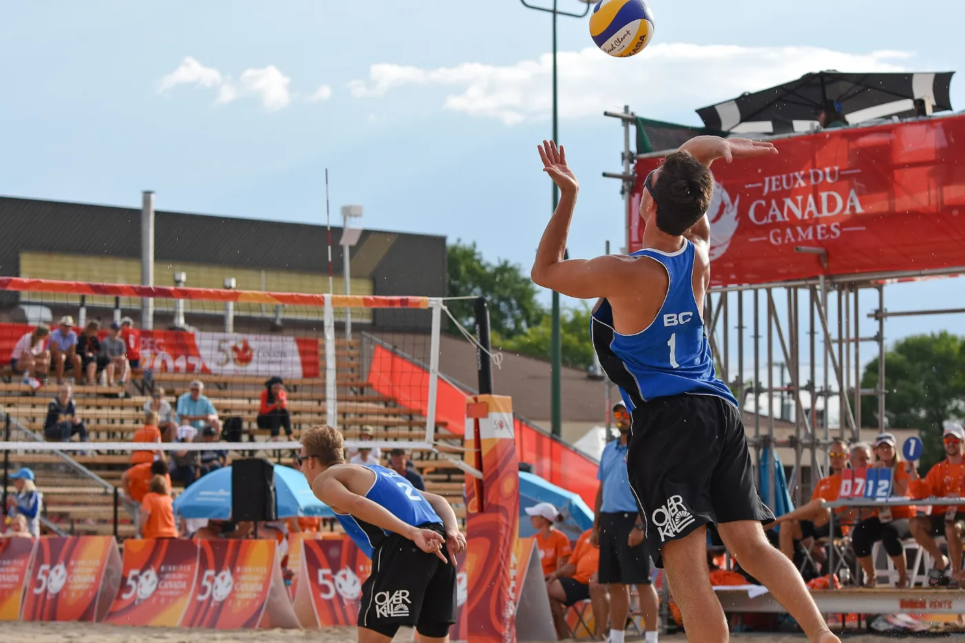 Two players during a beach volleyball game in the sand